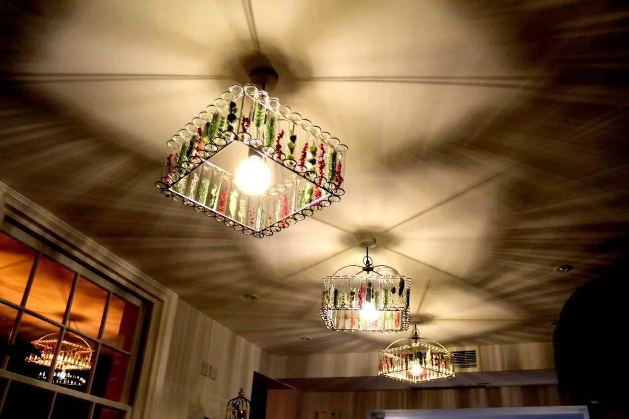 two chandeliers hanging from the ceiling of a room at 1 Craven Hill Gardens in London