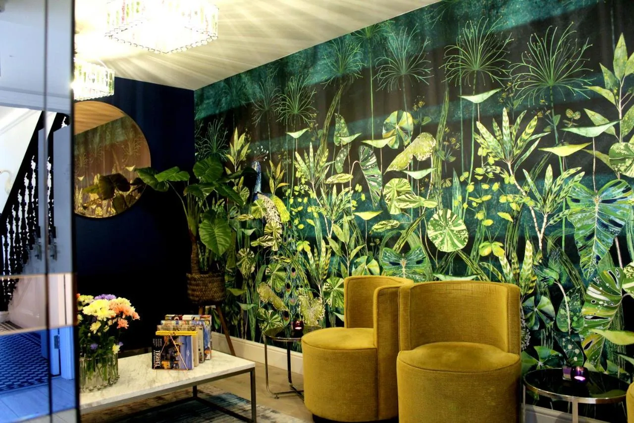 a room with chairs and a large mural of plants at 1 Craven Hill Gardens in London